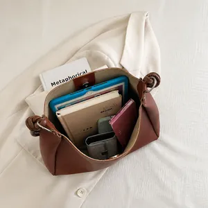 Brown retro bucket bag interior showing large capacity for tablet and notebooks