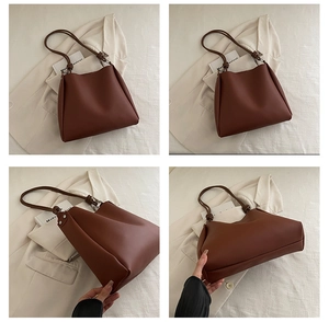 Detail view of brown leather tote bag with unique knotted straps and sturdy base structure