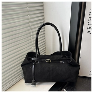Minimalist black faux suede tote bag with glossy leather straps and golden clasp