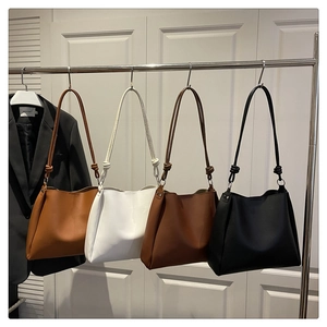 Detail view of large shoulder tote bags in caramel, beige, coffee, and black options