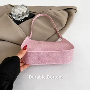 Close-up of pink glitter underarm bag featuring a durable and wear-resistant bottom