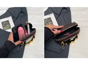 Interior view of brown leather bag showing main compartment with phone and makeup items