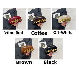 Detailed view of fashion clutch bags with wavy gold metal trim in five elegant colors