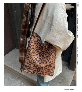 Detail view of large leopard print suede tote bag showing soft texture and shoulder strap
