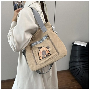 Khaki nylon bucket bag with cute capybara print and adjustable grey shoulder strap