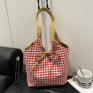 Red and white checkered canvas tote bag with khaki straps and decorative bow tie detail