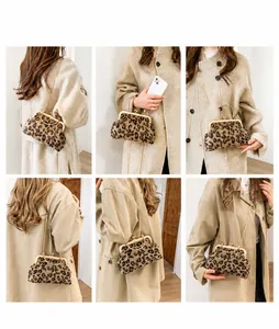 Close-up of leopard print shell bag with gold metal handle and chain strap details