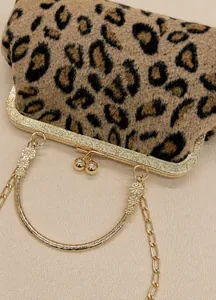 Close-up of leopard faux fur shell bag with embossed gold frame and clasp closure