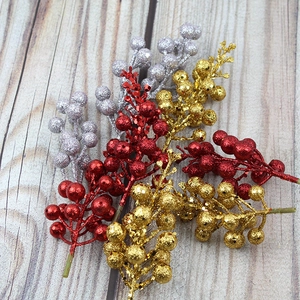 Glittery artificial Christmas berries in red, gold, and silver for holiday wreath decor