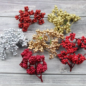 Detail of multi-colored foam Christmas berry stems with glitter finish for festive decor