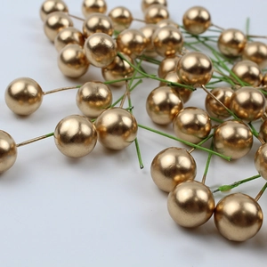 Macro detail of decorative gold berries with wire stems for Christmas DIY floral crafts