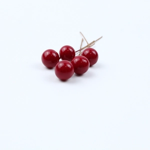Detailed view of 5 glossy red artificial berries with wire stems for Christmas DIY decor