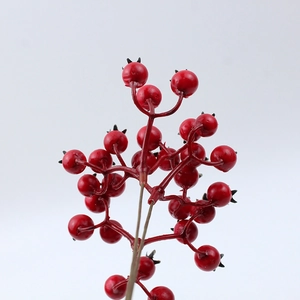Close-up of realistic red artificial berry branches for festive DIY home decorations