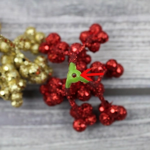 Macro view of Christmas berry branch base with hole for easy tree decoration and mounting