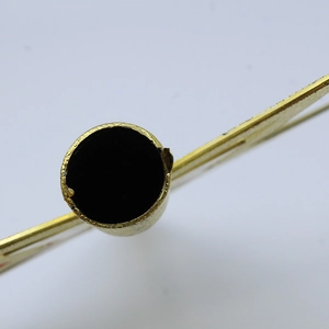 Macro view of gold metal cylindrical tube connector for Christmas tree star topper