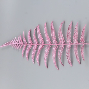 Macro shot of single pink glitter fern leaf ornament for Christmas tree decoration