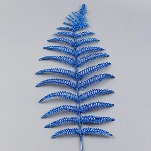 Macro shot of blue glitter fern leaf decoration for Christmas tree and festive ornaments