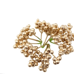 Golden artificial Christmas berry branches for festive floral arrangements and home decor