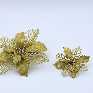 Close-up of golden glitter Christmas flowers with hollow design for tree DIY decor