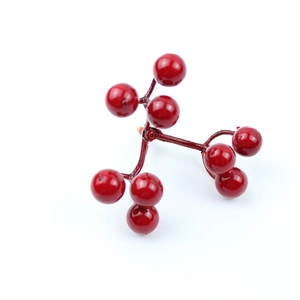 Detailed close-up of realistic artificial red berries on brown stems for festive decor
