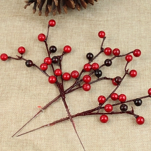 Artificial red berry branches on linen background for Christmas home decoration