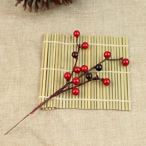 Artificial red and purple berry branches on linen background for Christmas home decoration