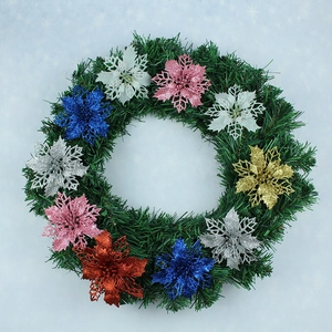 Christmas wreath detail with colorful glitter hollow flowers and green pine needles