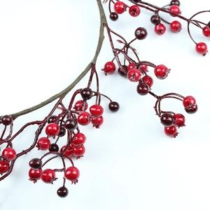 Close-up of artificial red and purple berries with glossy finish for festive home decor
