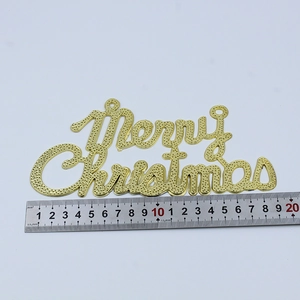 Golden Merry Christmas sign with dotted texture and steel ruler for size reference