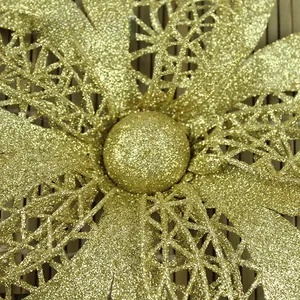 Macro shot of gold glitter Christmas flower detail with hollow mesh petals and core