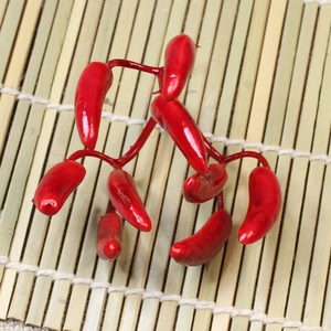 Artificial red pepper berry clusters on bamboo mat for Christmas decoration