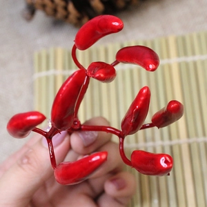 Macro shot of red artificial mini chili berries with glossy finish for Christmas decor