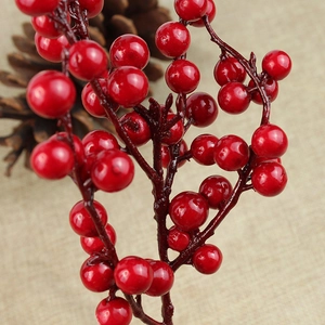 Close-up of realistic red berries on a branch for Christmas tree and holiday decoration