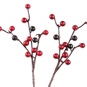 Close-up of glossy red and dark purple artificial holly berries for Christmas decor