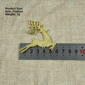 Detail shot of a 6cm golden reindeer ornament with textured finish and measurement scale