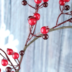 Macro shot of realistic red berries and natural wood texture on a Christmas wreath