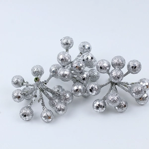 Macro shot of sparkling silver glitter berry cluster decorations for Christmas wreaths