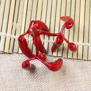 Artificial mini red chili cluster ornaments for Christmas decoration on bamboo background