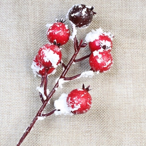Artificial red holly berries with frosted snow texture for Christmas decoration