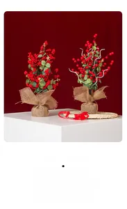 Dettaglio di agrifoglio artificiale con bacche rosse e base in juta per decorazione