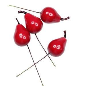 Close-up of artificial mini red pears with glossy finish and realistic dark stems