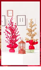 Close-up of artificial red and gold berry trees in festive lucky bag base design