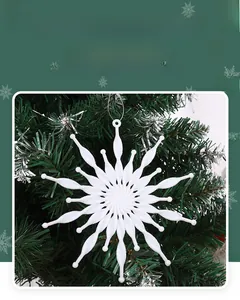Close-up of a white 3D snowflake ornament with relief texture hanging on a Christmas tree