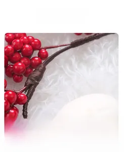 Detail of red Christmas berries with meticulous brown wire wrapping for festive decoration