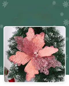 Macro detail of pink glitter hollowed-out Christmas flower with pearl center for tree decor