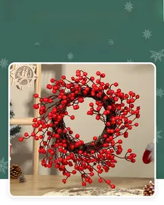 Close-up of vibrant red artificial berries on 30cm Christmas wreath with vine base