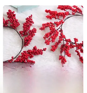 Close-up of vibrant red artificial berry wreath on a soft white plush background