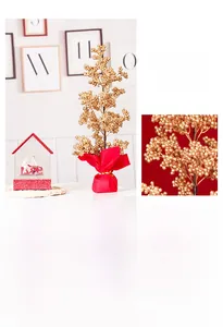 Close-up of artificial golden berry tree centerpiece with festive red fabric base