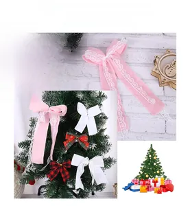 Detail of Christmas fabric bows in pink lace, white, and festive plaid patterns for DIY decor