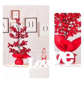 Detailed close-up of vibrant red artificial holly berries and festive base decoration